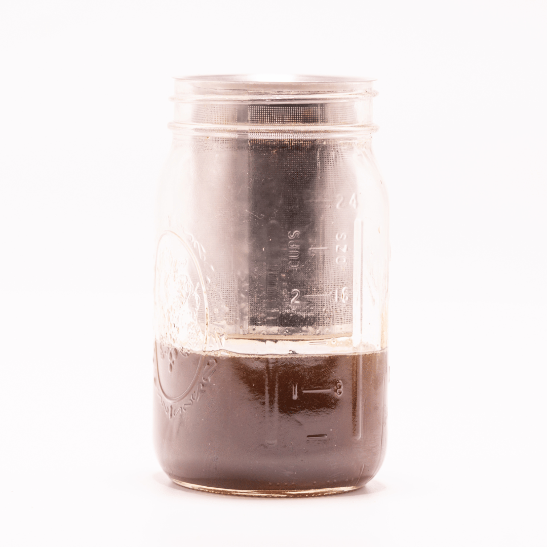 Finished infusion collected in a glass jar below a CannaFuse strainer